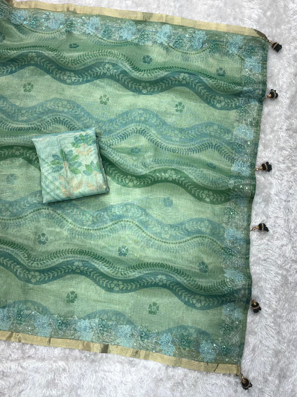 Woman wearing premium sea green silk blend saree for festive occasions.