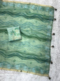 Woman wearing premium sea green silk blend saree for festive occasions.