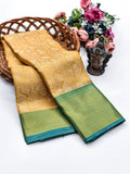 Traditional yellow Kanjivaram silk saree with green border for weddings and festive wear.