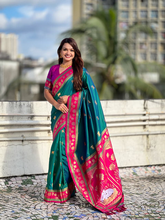 Peacock teal Paithani silk saree with Rani pink lotus zari border and traditional Maharashtrian pallu.