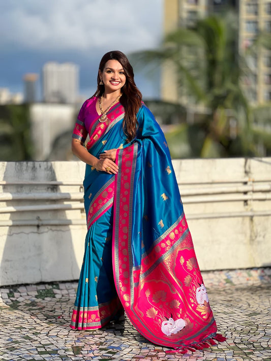 Royal azure blue Paithani silk saree with fuchsia pink lotus pallu and traditional Maharashtrian zari border.