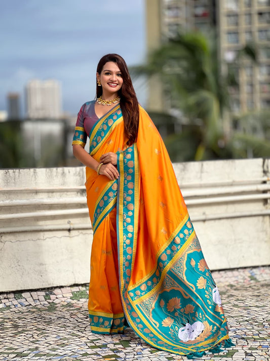 Mustard orange Paithani silk saree with teal blue lotus zari border and traditional Maharashtrian pallu design.