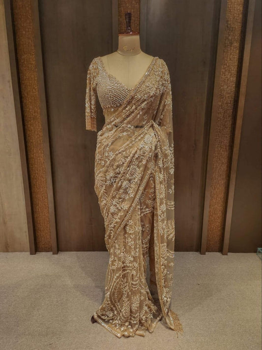 Champagne golden heavy net bridal saree with white pearl and cutdana embroidery handwork by Saree Sargam