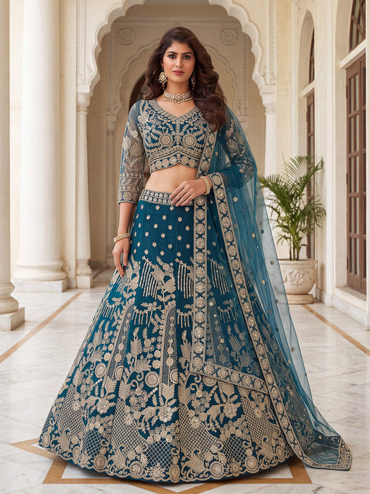 Teal blue net lehenga choli with heavy gold zari embroidery and matching sheer dupatta