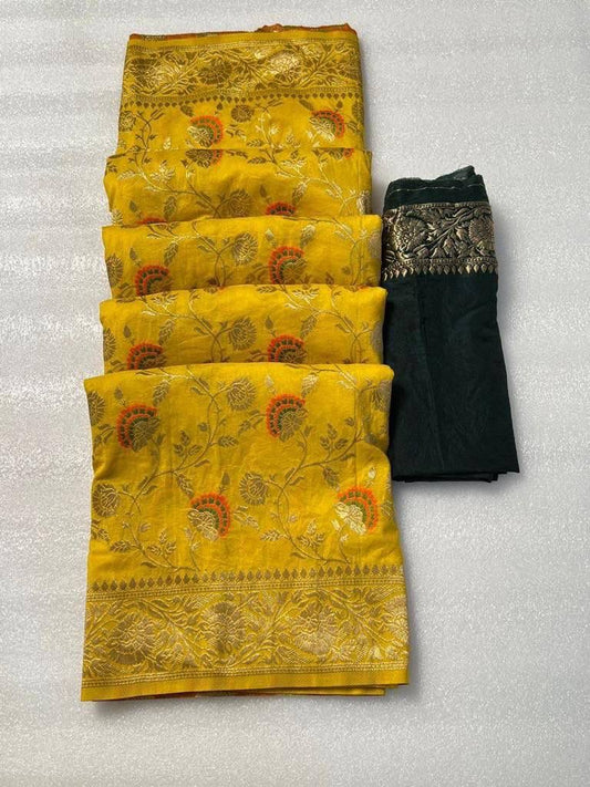 Folded yellow pure dola crepe silk saree featuring elegant floral weaving and a rich golden zari border