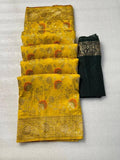 Folded yellow pure dola crepe silk saree featuring elegant floral weaving and a rich golden zari border