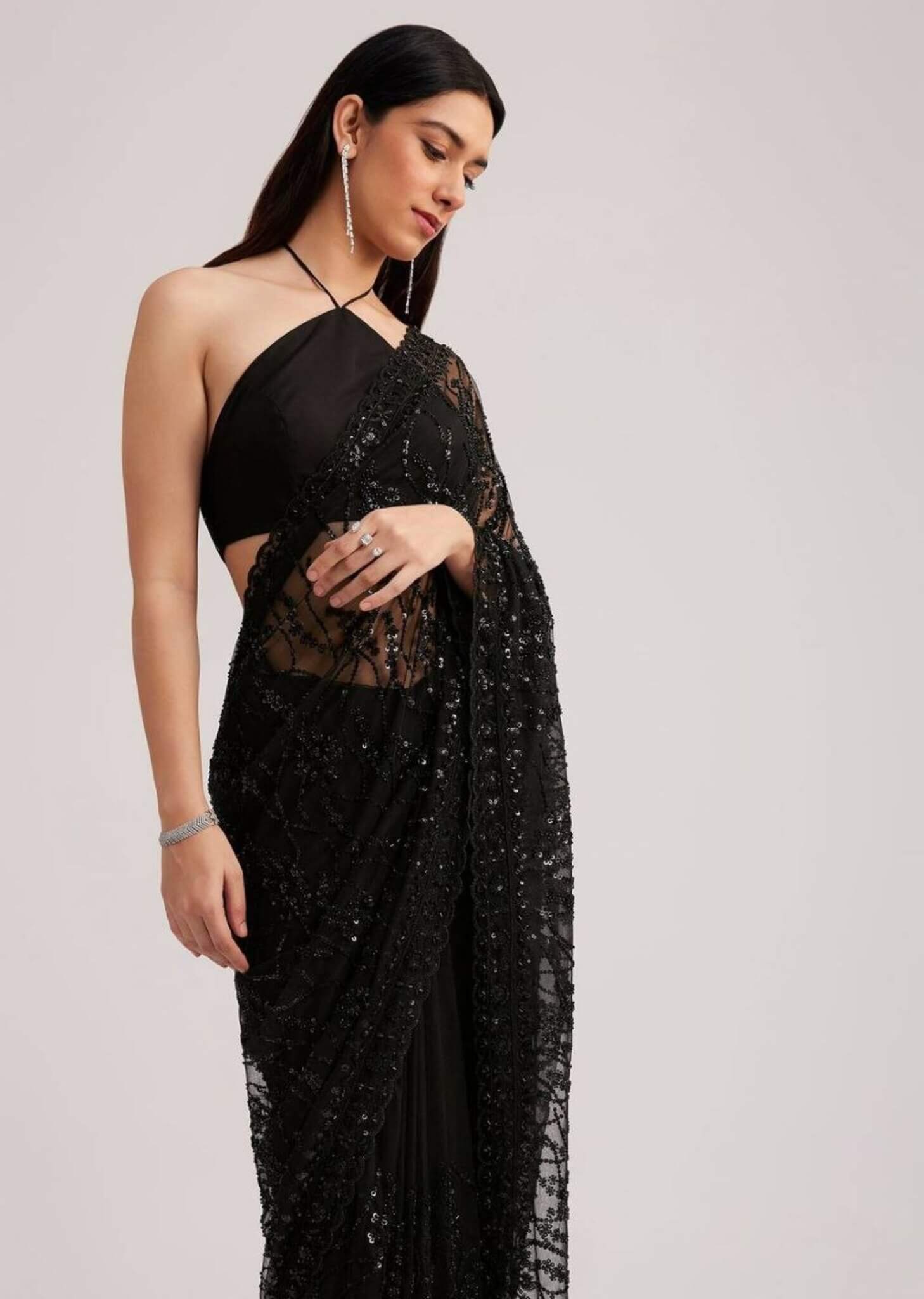 Close-up shot of the designer black saree blouse featuring elegant shoulder straps and sleek fit.