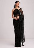 Midnight black net saree with heavy sequin embroidery and matching halter-neck blouse.