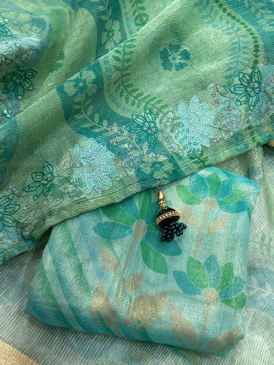 Designer sea green ethnic saree with floral motifs and graceful drape.