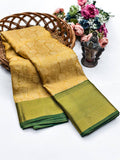 Vintage style ochre gold wedding saree featuring a muted olive green selvedge.