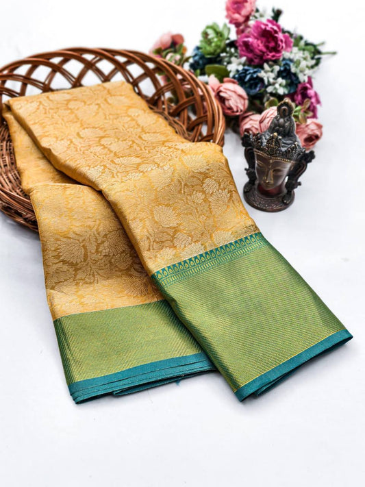 Traditional yellow Kanjivaram silk saree with green border for weddings and festive wear.
