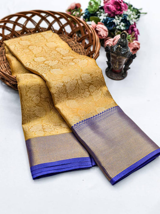 oney gold Kanjivaram silk saree featuring a vibrant royal purple jacquard border.