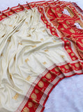 Designer white ethnic saree with vibrant coral pink border and premium silk texture for special occasions.