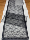 Detailed view of the sheer black net saree pallu decorated with intricate floral sequin patterns.