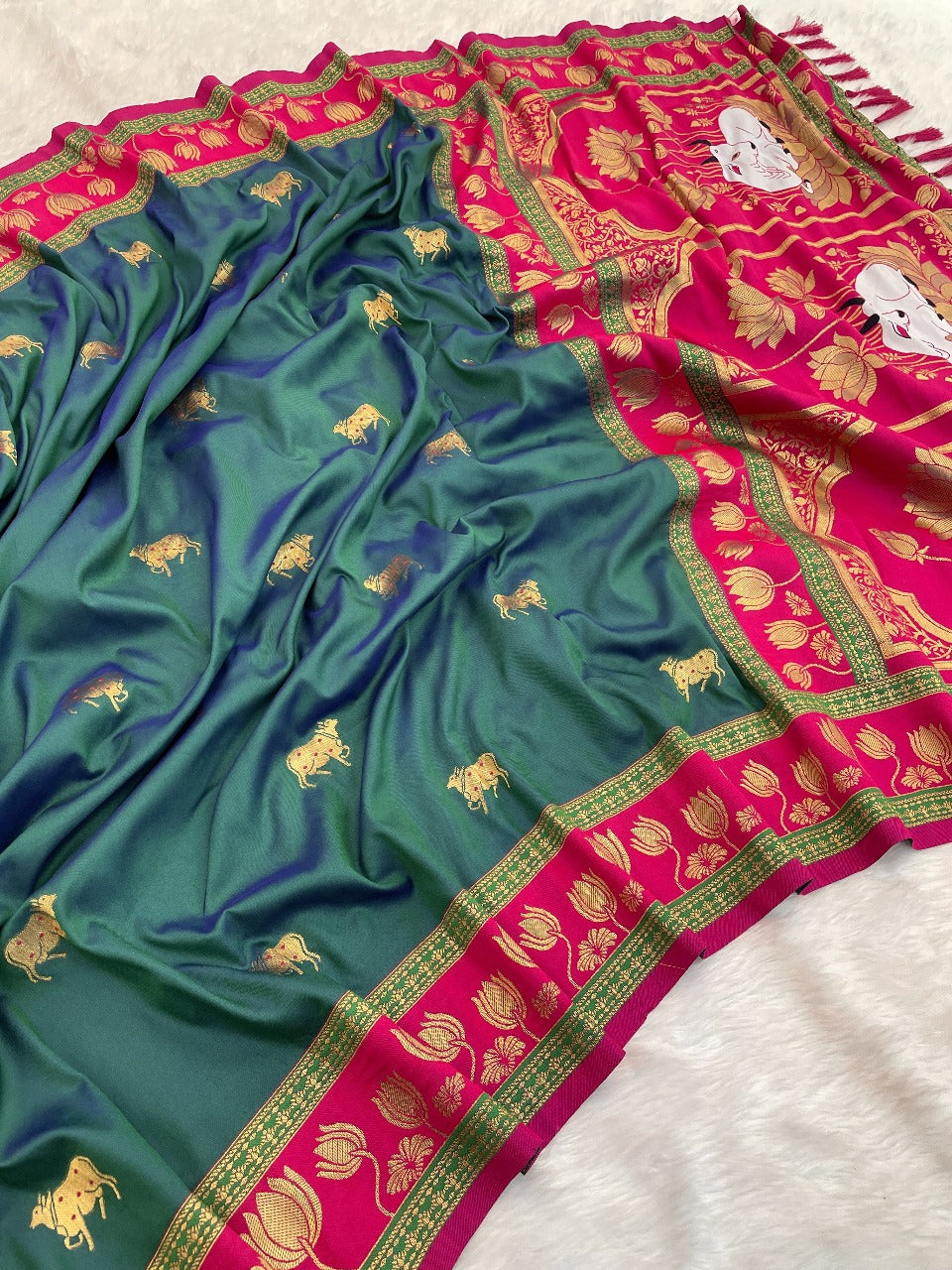 Premium Paithani silk saree showcasing teal body, pink lotus pallu and intricate zari detailing.