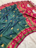 Premium Paithani silk saree showcasing teal body, pink lotus pallu and intricate zari detailing.