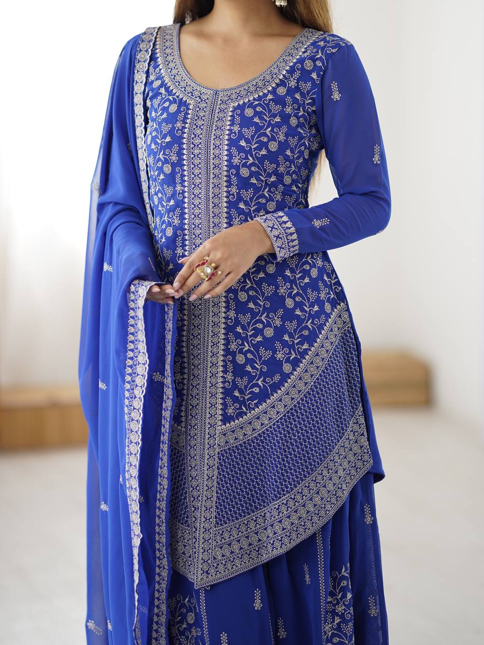 Three-piece party wear royal blue embroidered salwar kameez set featuring flared sharara pants