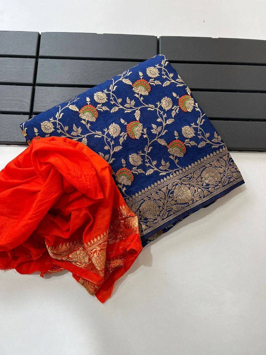 Royal blue pure georgette silk saree laid flat next to a folded bright orange woven blouse piece