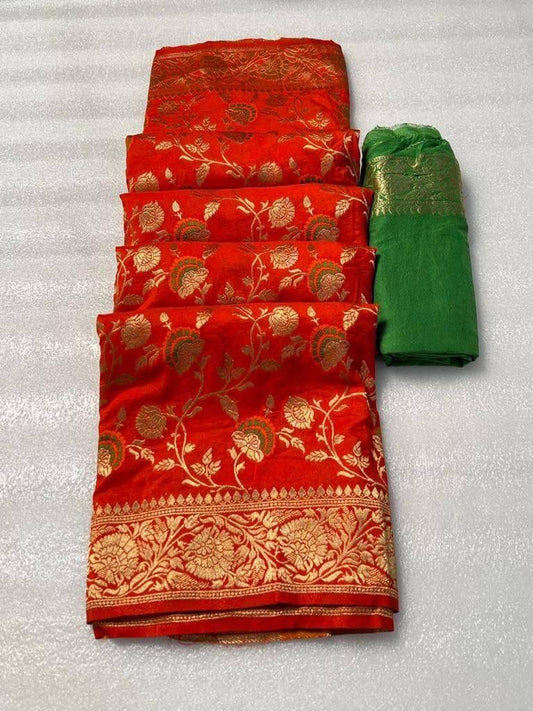 Vibrant red pure georgette silk saree laid flat next to a folded bright green woven blouse piece