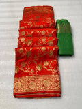 Vibrant red pure georgette silk saree laid flat next to a folded bright green woven blouse piece