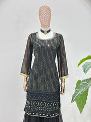Black embroidered dress on a mannequin with a white background